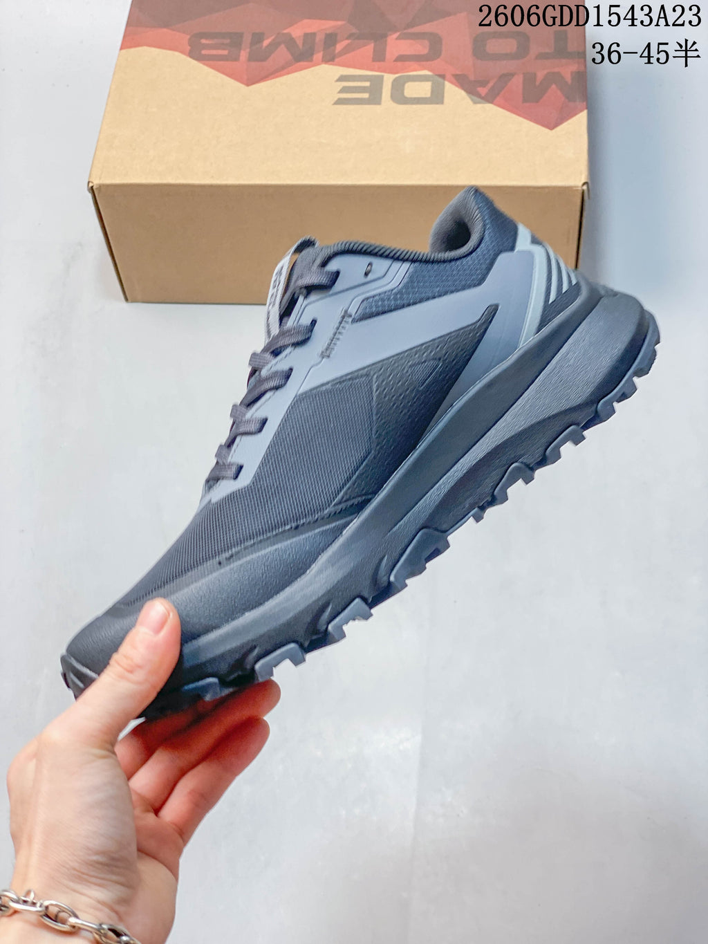 Side profile of a gray trail running shoe with rugged outsole