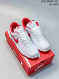 Pair of white and red Nike Big Nike Low Lux low-top sneakers on a red shoe box