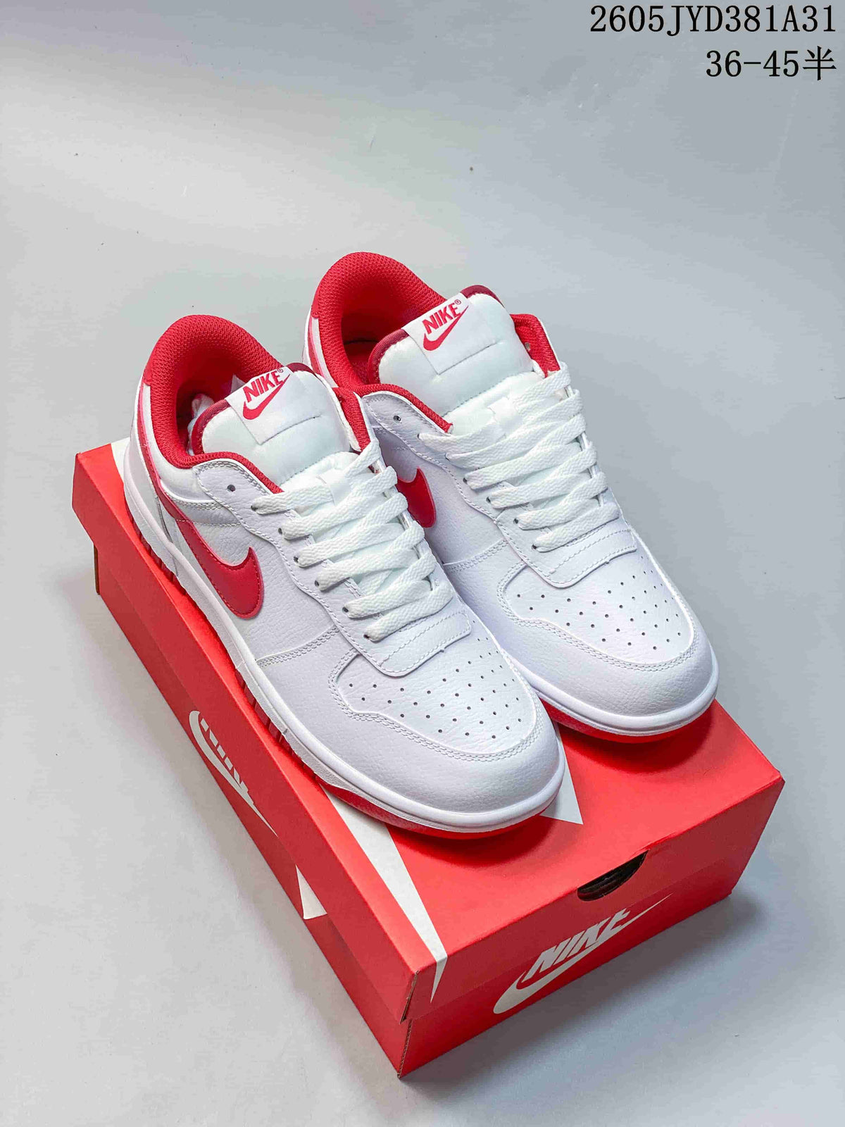Pair of white and red Nike Big Nike Low Lux low-top sneakers on a red shoe box