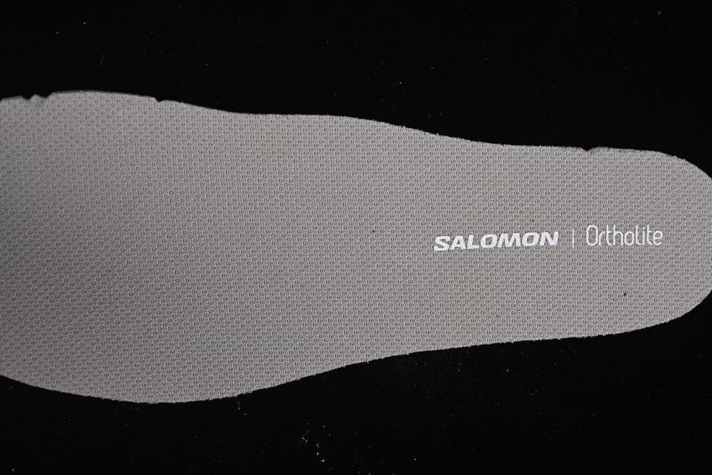 Close-up of a gray insole marked Salomon and Ortholite.