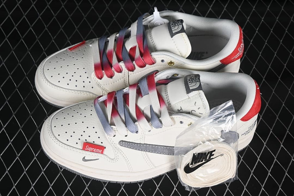 Pair of off-white low-top sneakers with gray and red details, gradient laces, and an extra lace pack.