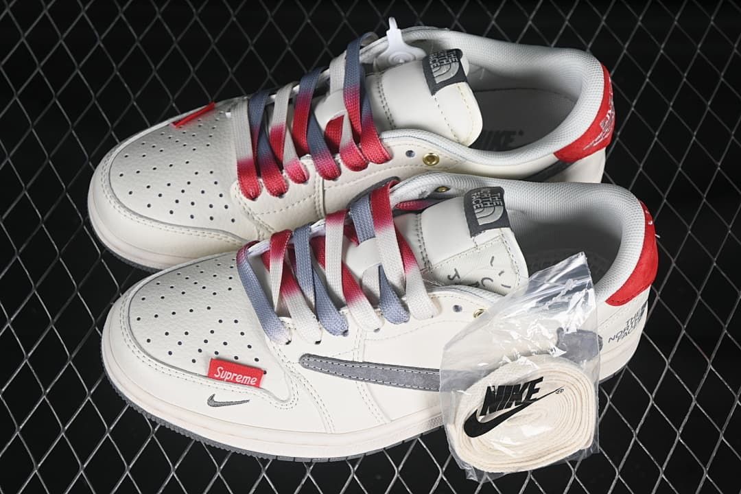 Pair of off-white low-top sneakers with gray and red details, gradient laces, and an extra lace pack.