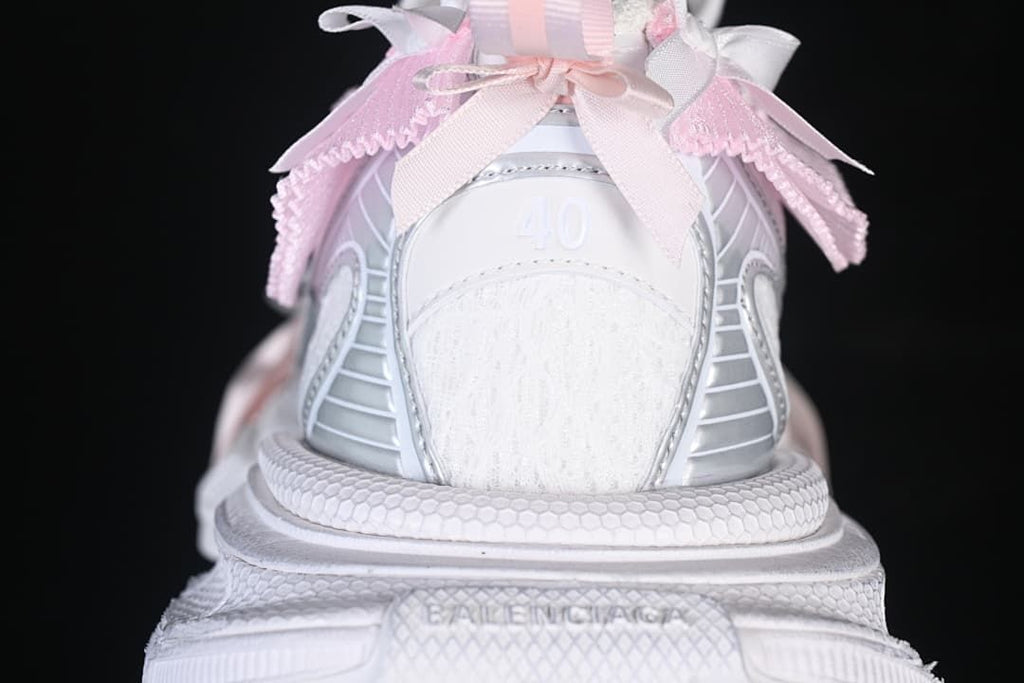 Rear view of the sneaker showing pink ribbon details and a chunky heel.