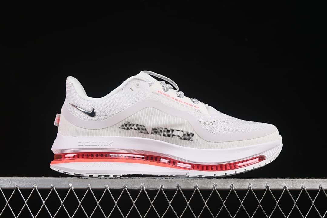 Side view of the shoe showing the mesh upper, large side branding, and red midsole unit.