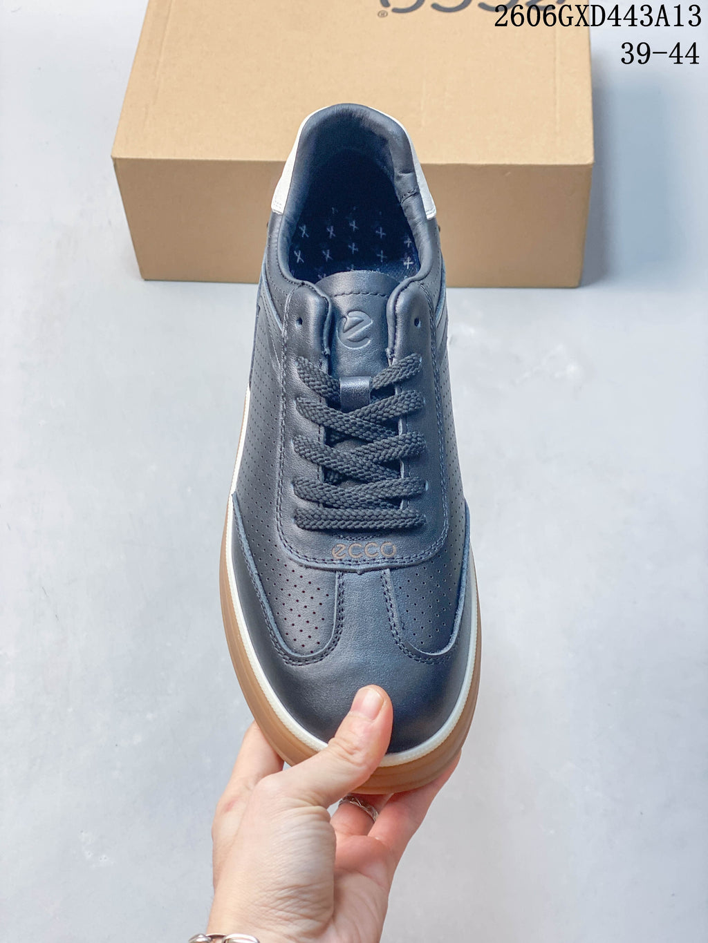 Front view highlighting the laces, perforated panels and navy upper