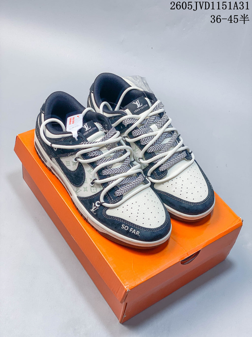 Pair of cream low-top sneakers with navy overlays, patterned side panels, and perforated toe boxes.