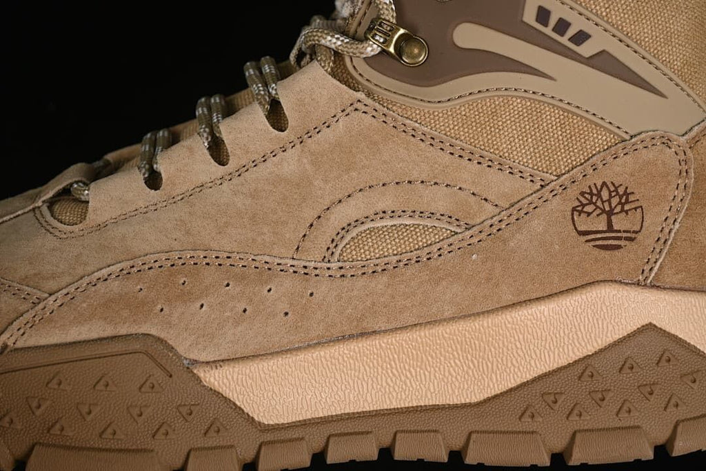 Close-up of the side panels, Timberland tree logo, lace hooks, and tread.