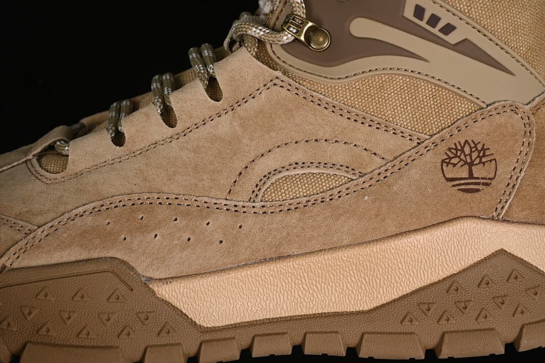 Close-up of the side panels, Timberland tree logo, lace hooks, and tread.