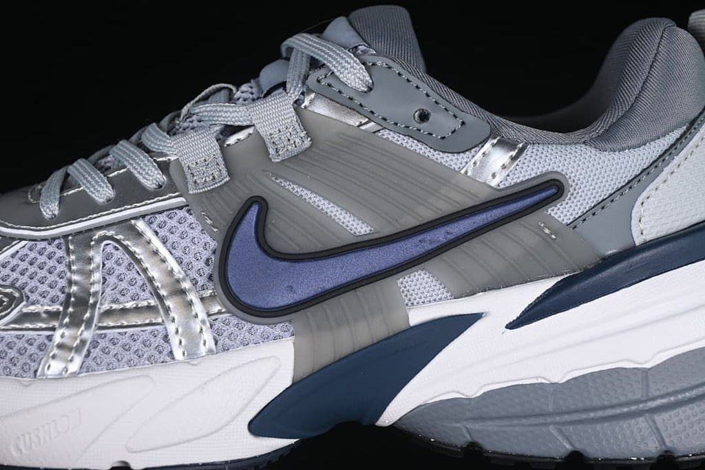 Close-up of the side panels, laces, and navy Swoosh