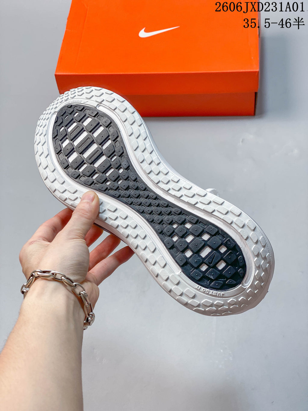 Underside of a Nike Vomero Plus shoe showing the patterned outsole.