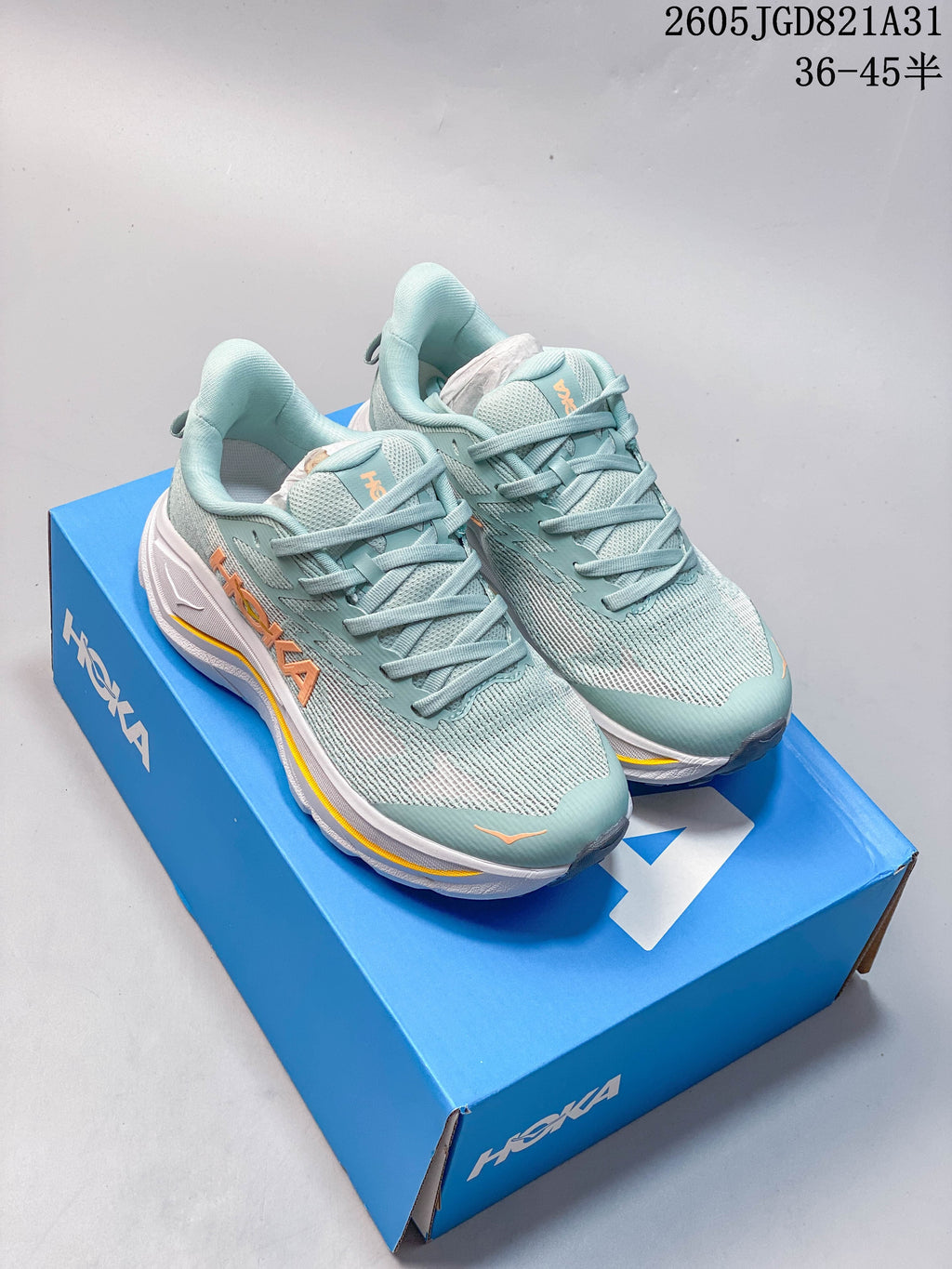 Pair of light blue HOKA Challenger 8 running shoes on a blue box
