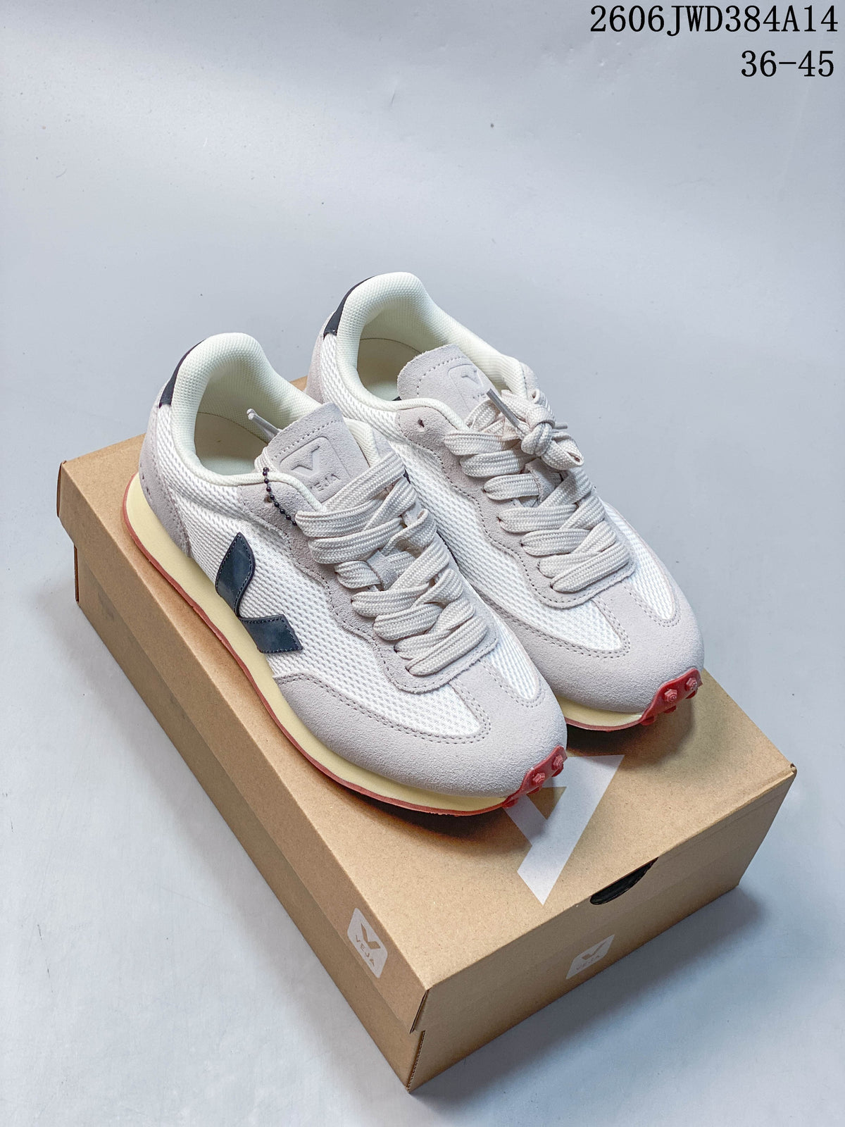 Pair of white and gray Veja Esplar sneakers with navy side logos, cream midsoles and red outsoles