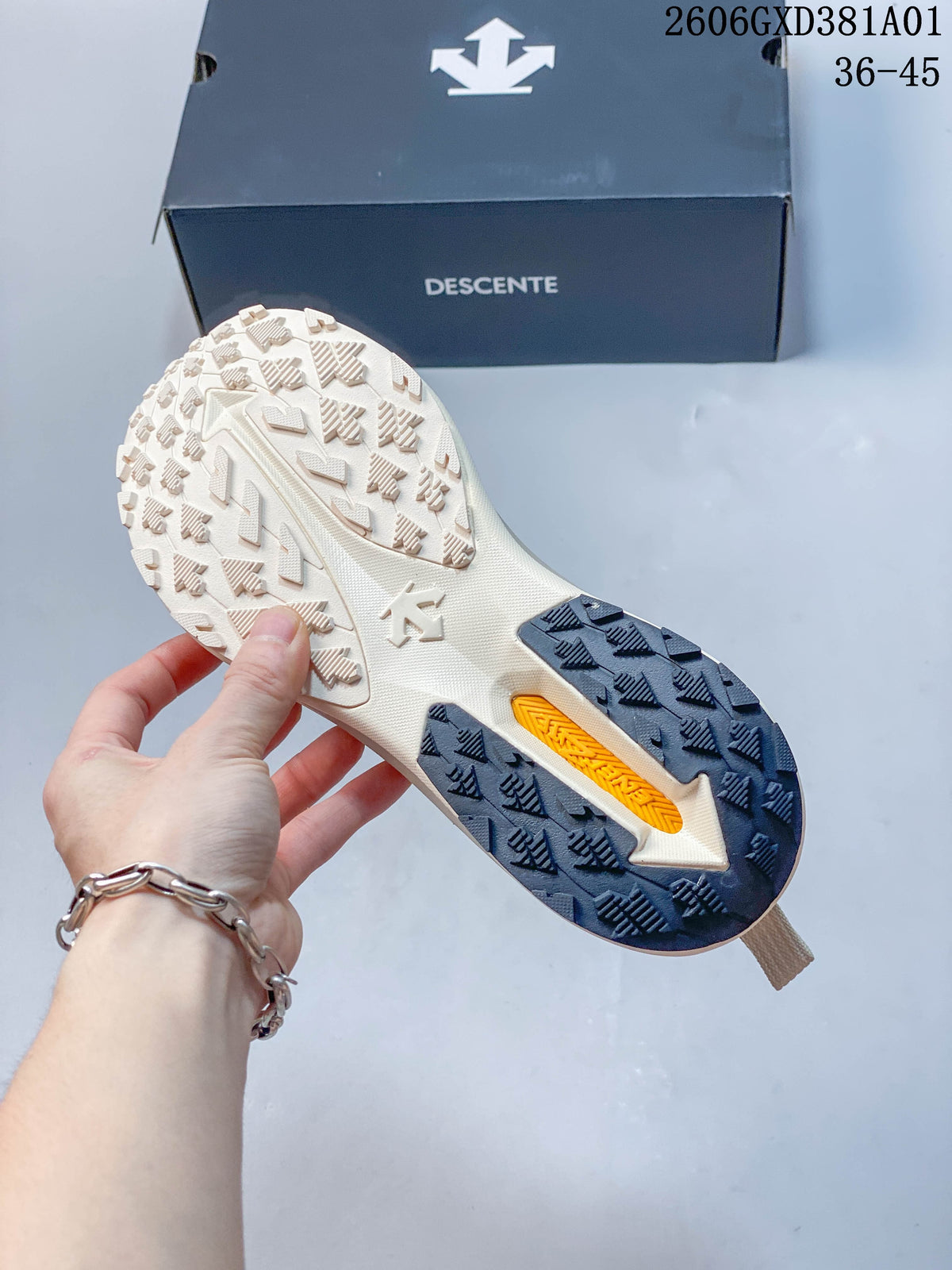 Close-up of the patterned outsole on a beige DESCENTE sneaker