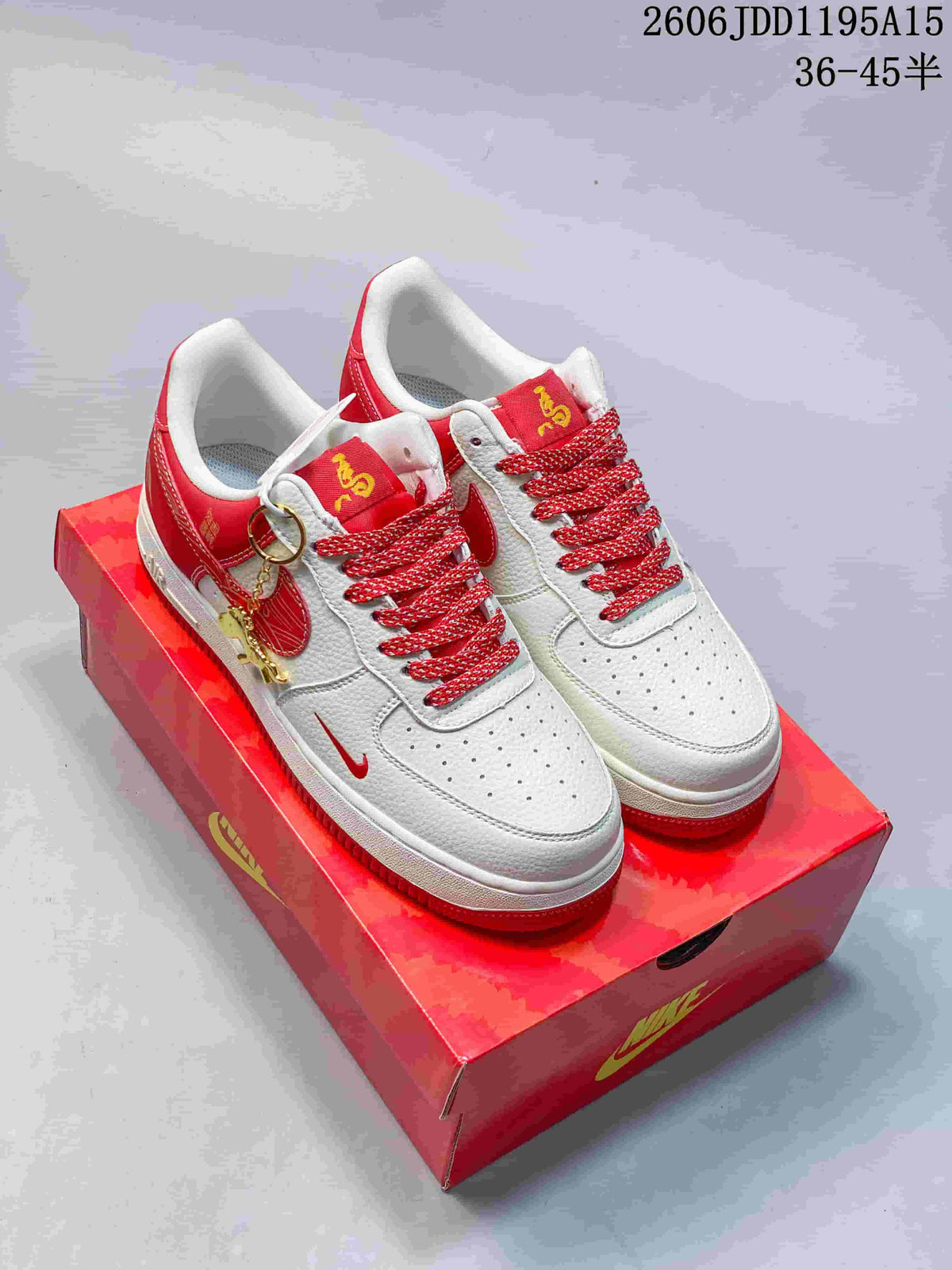 Pair of white and red low-top sneakers with horse-themed details, patterned red laces, decorative charms, and a red box