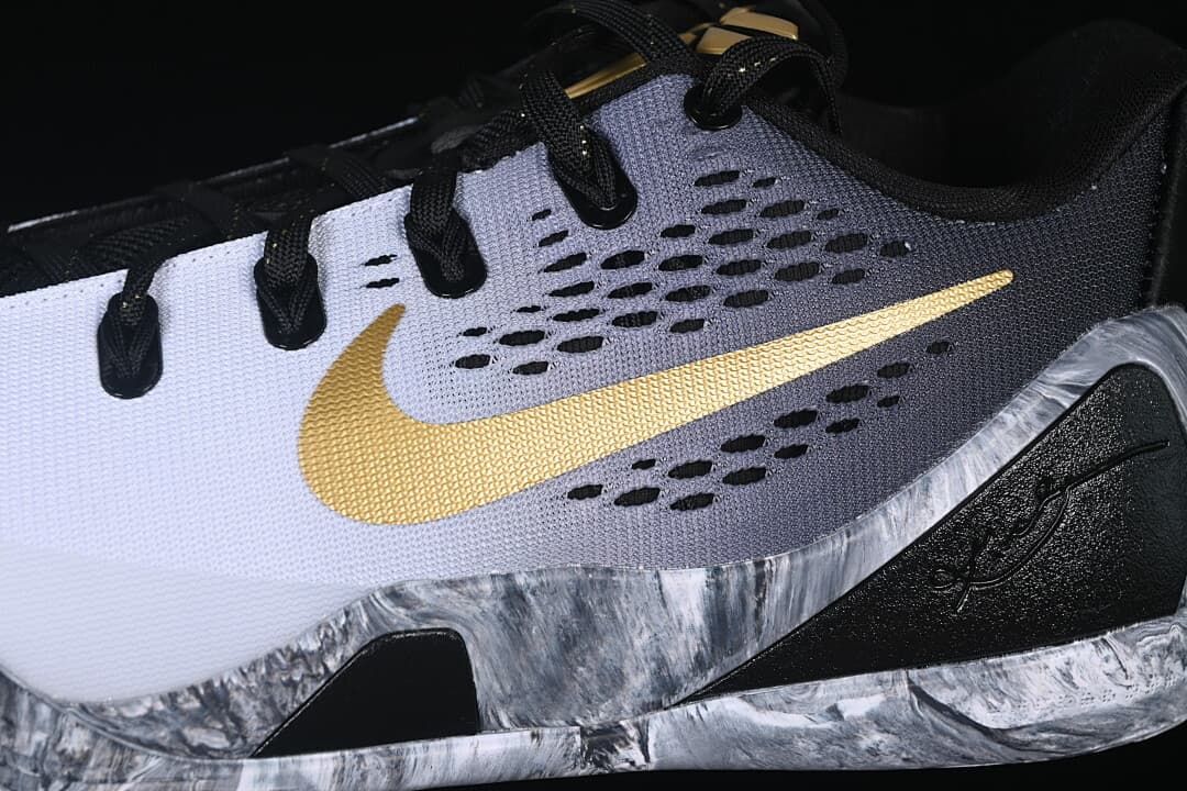 Close-up of the gold Swoosh and perforated gray side panel