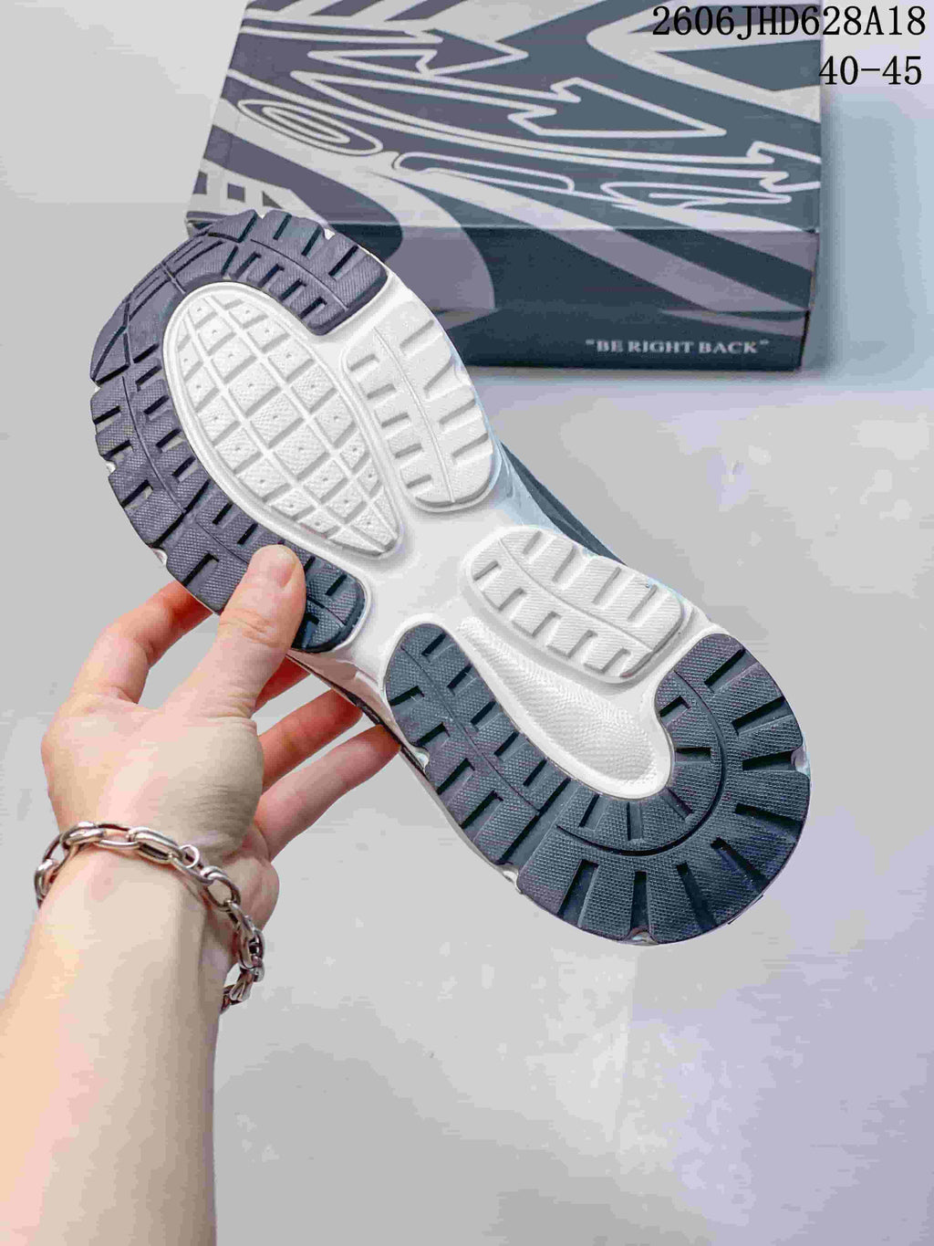 Underside of the sneaker showing a segmented outsole and tread pattern