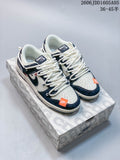 Pair of off-white and navy Nike SB Dunk Low sneakers with orange accents on a patterned box