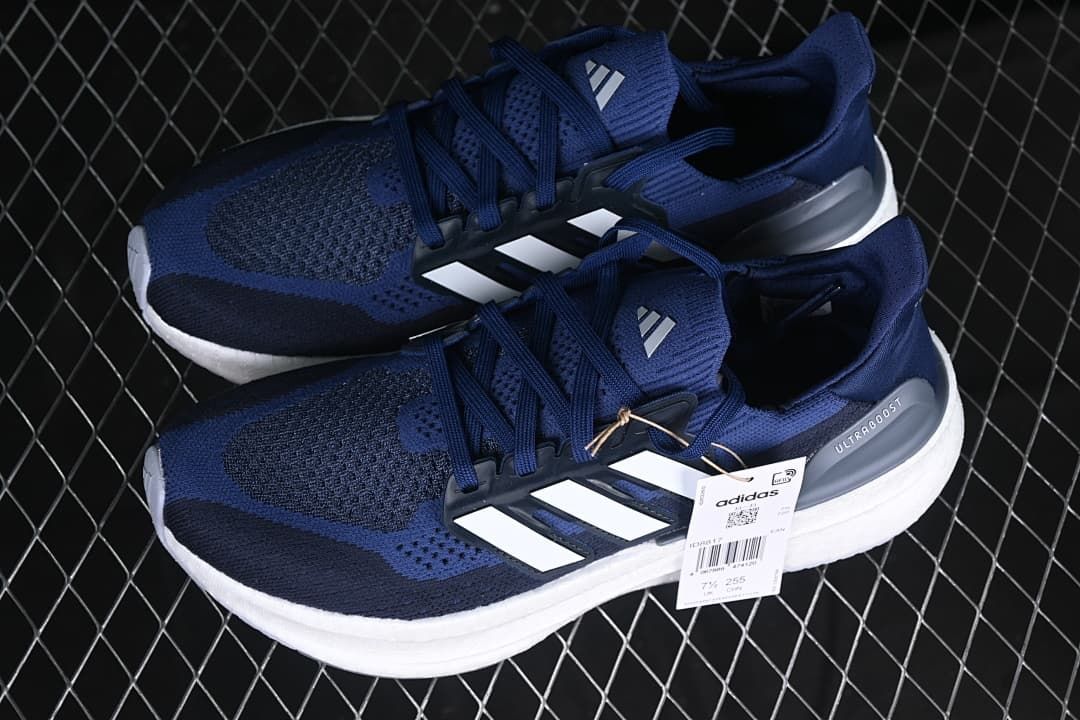 Pair of blue adidas Ultraboost 5 shoes with white stripes.