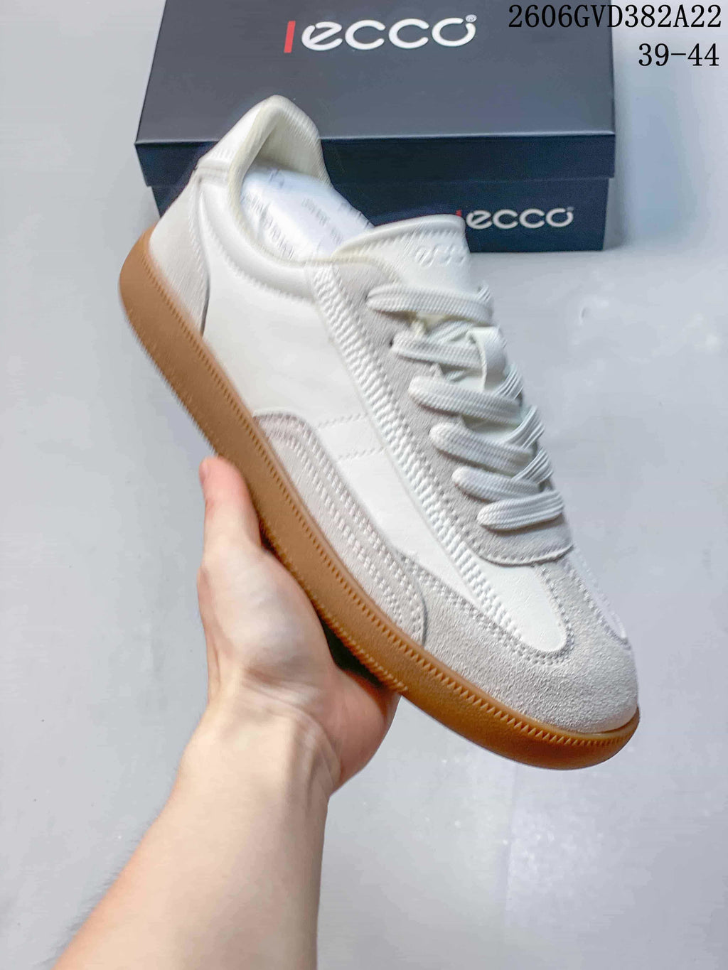 Side view of an off-white ECCO low-top lace-up sneaker with a gum-colored sole.