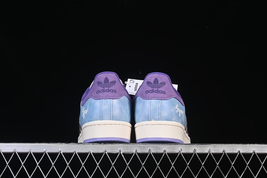 Rear view of both sneakers showing purple heel tabs
