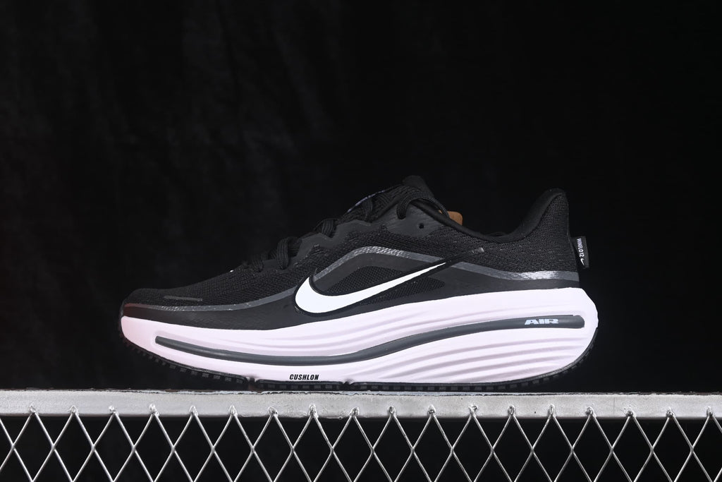 Side profile of a black and white Nike Zoom Winflo 12 sneaker showing the layered upper and cushioned midsole.