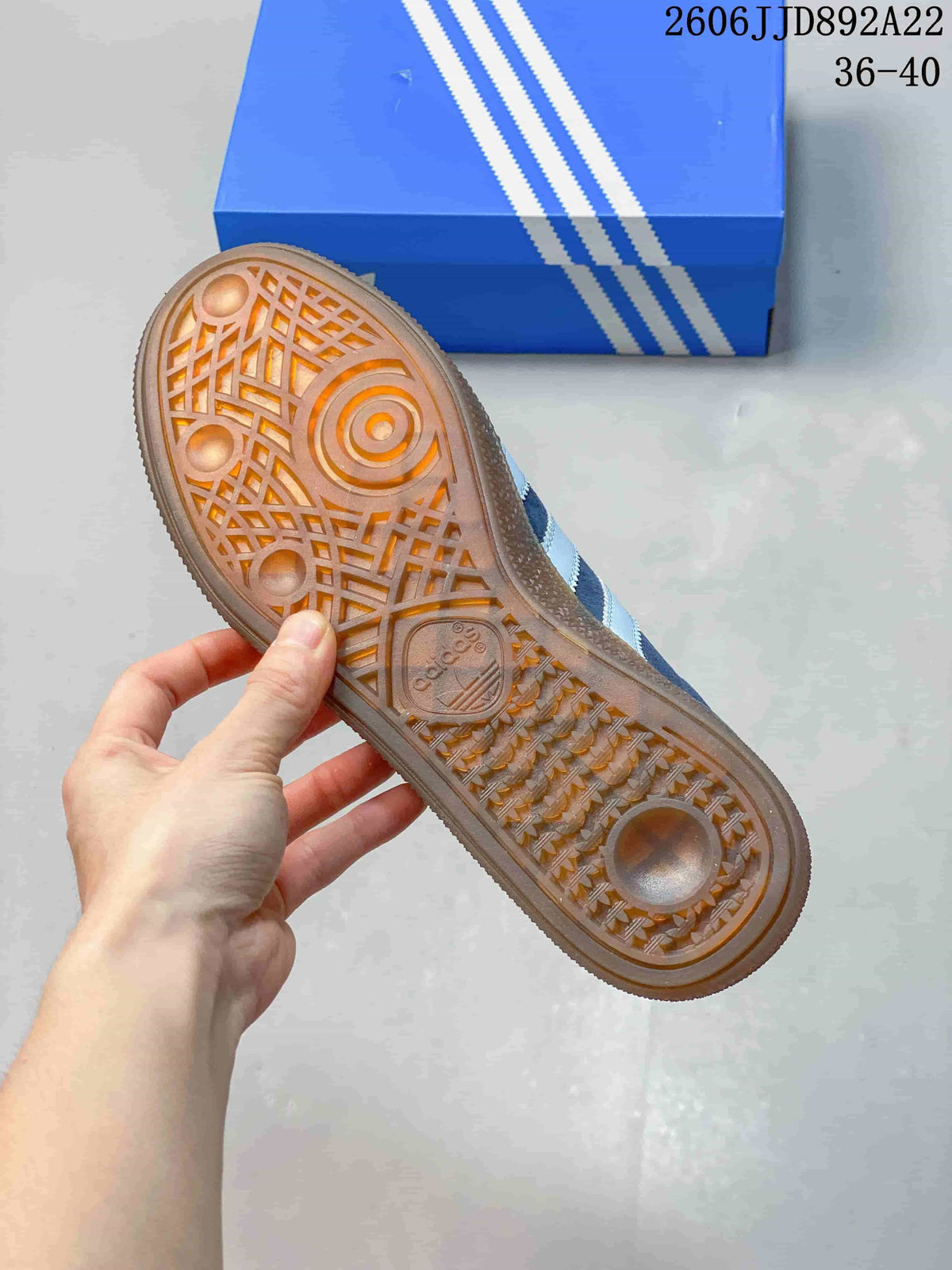 Gum-colored outsole with patterned tread on a blue sneaker