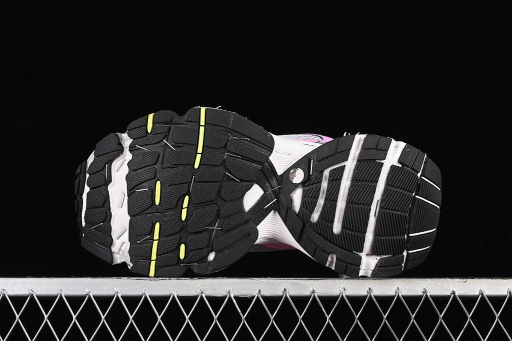 Underside view showing the black rubber outsoles with yellow accents