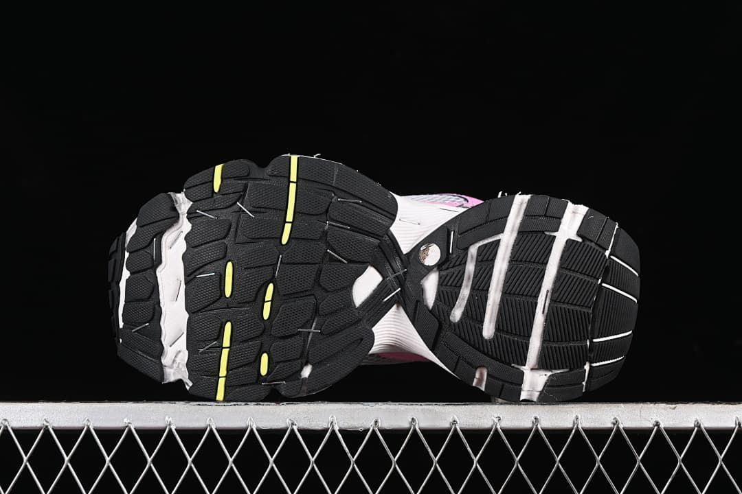 Underside view showing the black rubber outsoles with yellow accents