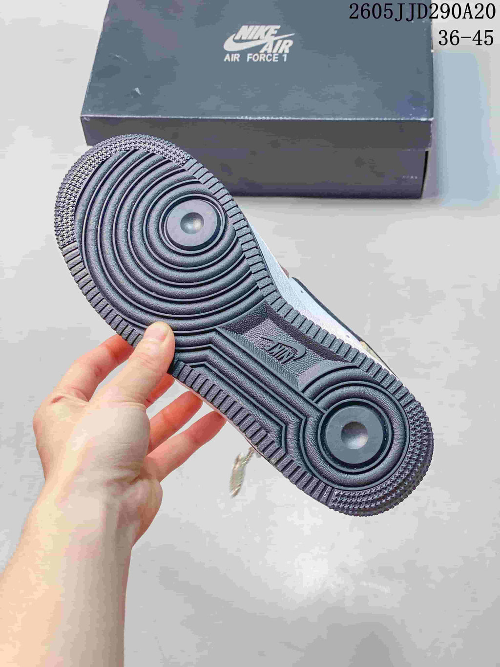 Underside view showing the sneaker outsole and circular tread pattern