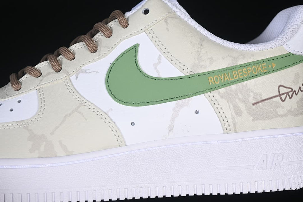 Close-up of the green side accent, brown signature detail, and patterned overlays