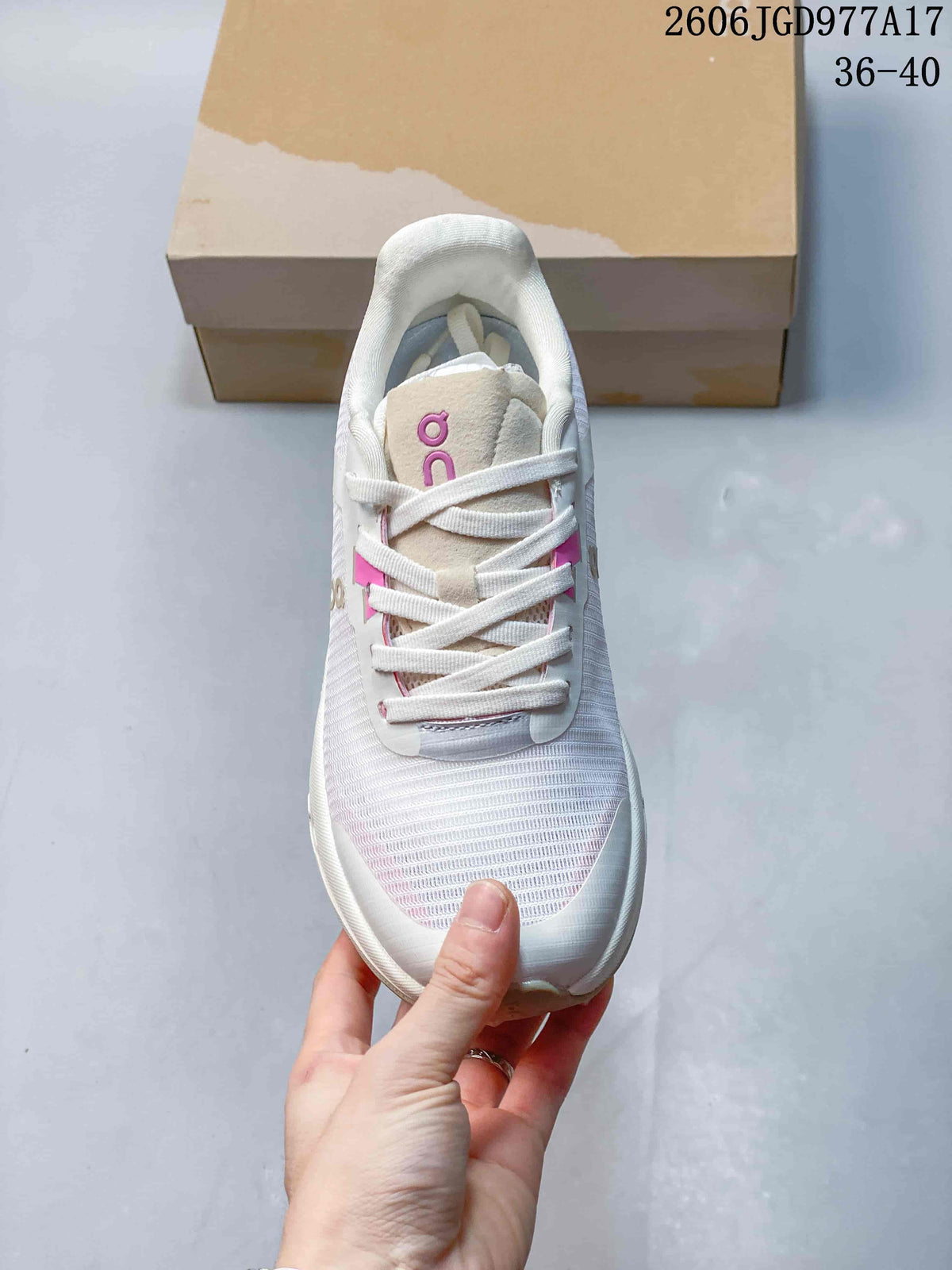 Top view of the white and pink lace-up shoe.