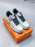 Pair of off-white low-top sneakers with dark laces and swoosh details on an orange shoebox.