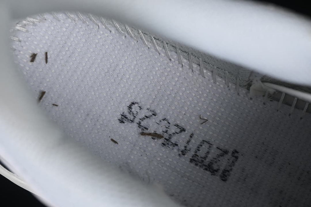 Close-up of stitching and printed markings inside the shoe
