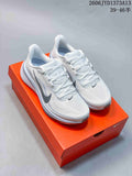 Pair of white Nike Pegasus 42 running shoes with gray accents on an orange shoebox