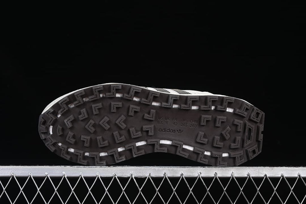 Underside of the sneaker with patterned dark outsole and size markings