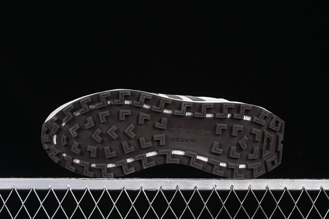 Underside of the sneaker with patterned dark outsole and size markings