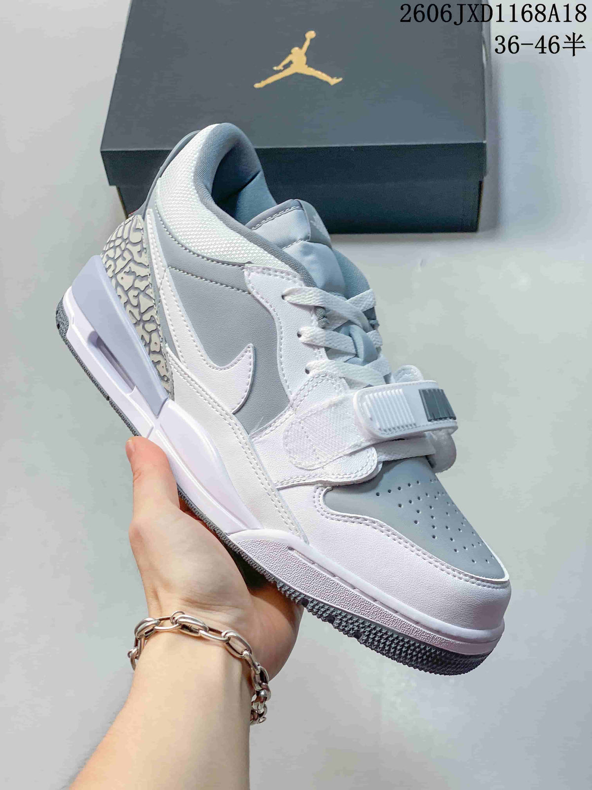 Angled side view of a white and grey Jordan Legacy 312 sneaker