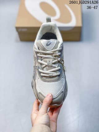 Front view of the ASICS GEL-NYC RGD sneaker showing the mesh toe box, layered upper, and gray laces.
