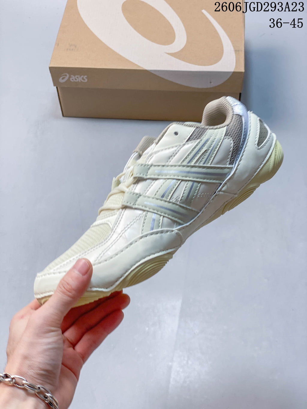 Side profile of the cream sneaker with layered panels and lace-up fastening