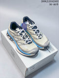 Pair of ivory and blue Salomon XT-6 shoes displayed on a box