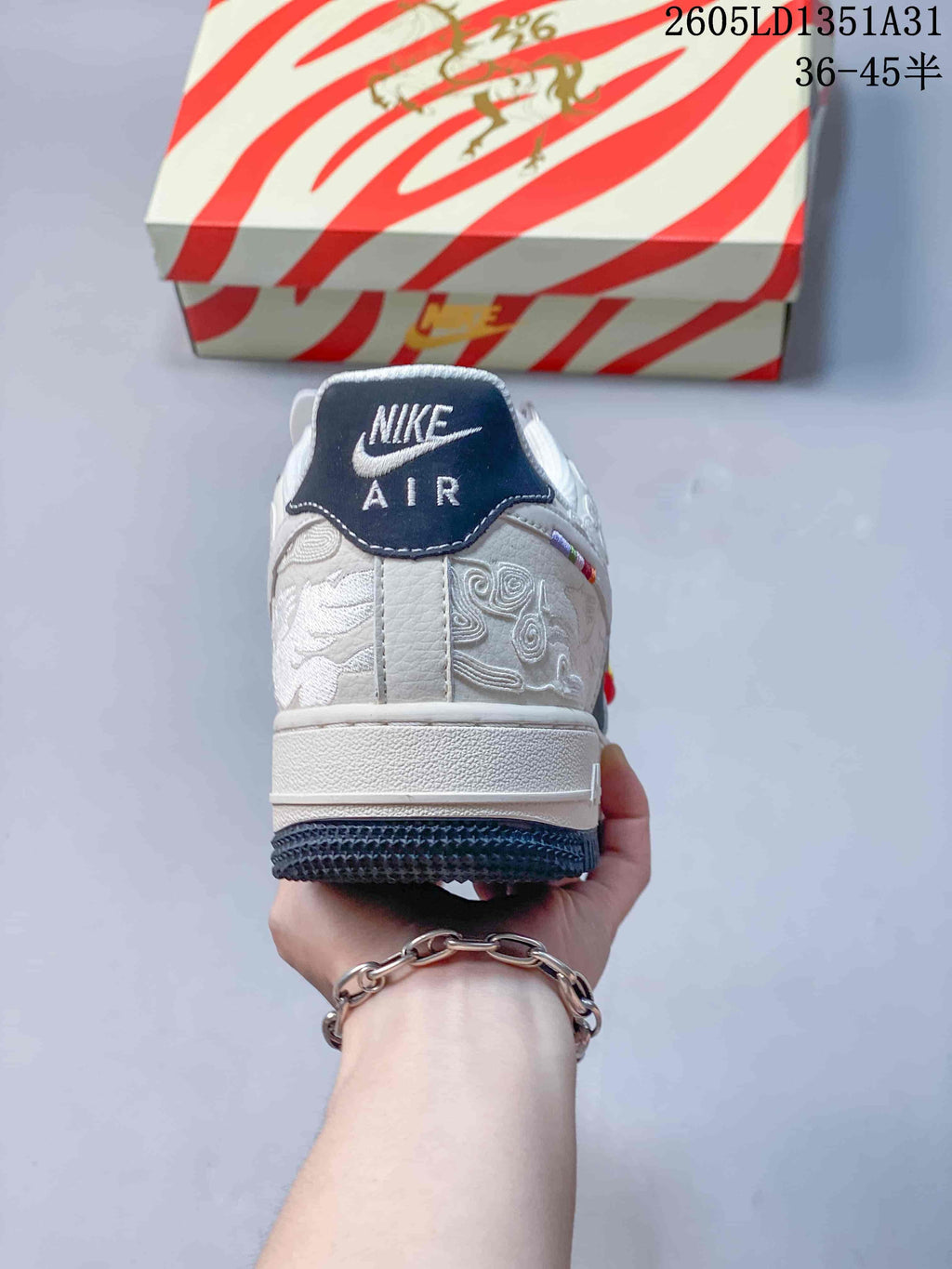 Rear view showing embroidered details and a navy heel tab