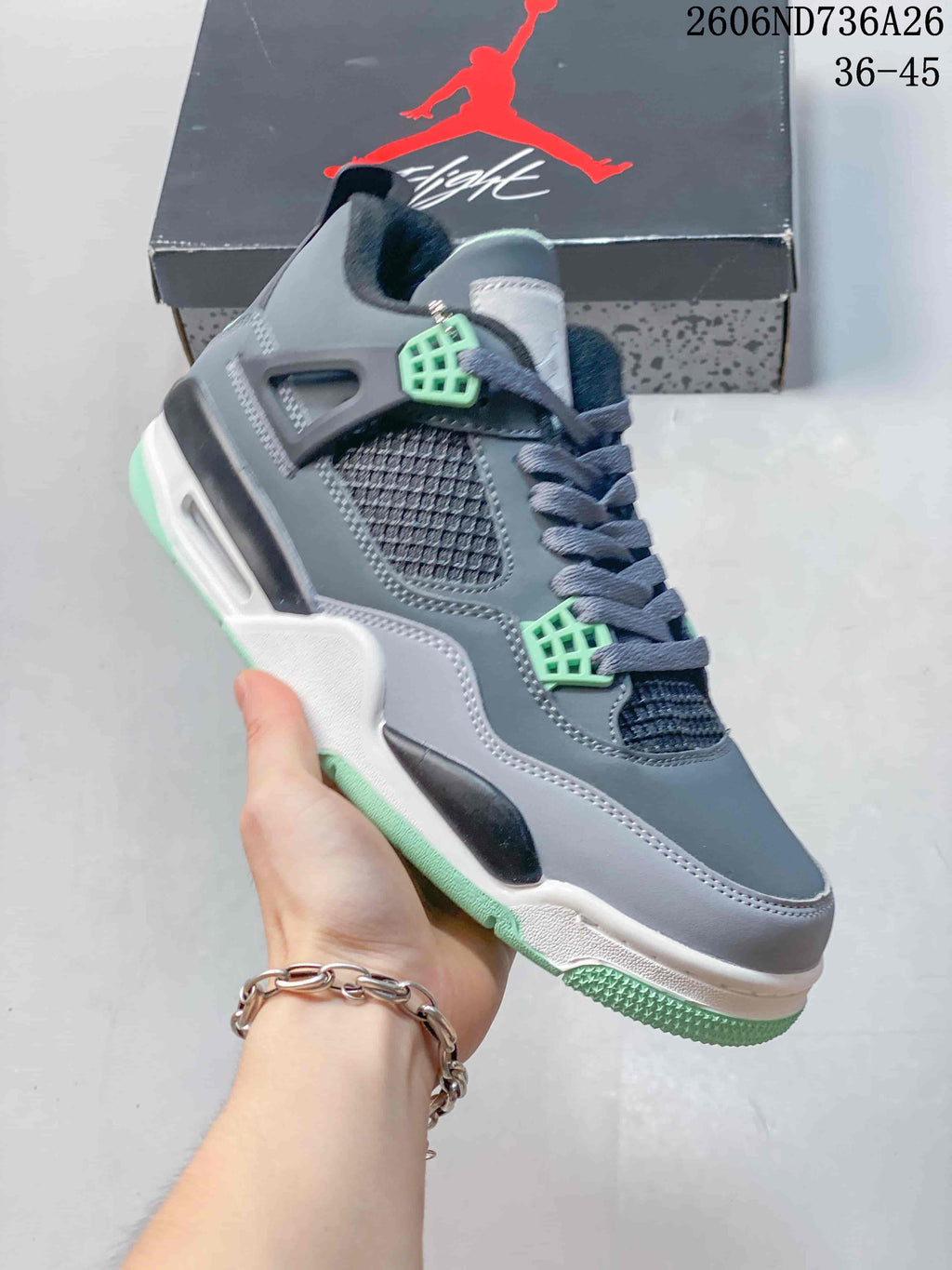 Angled side view of the grey and mint-accented sneaker