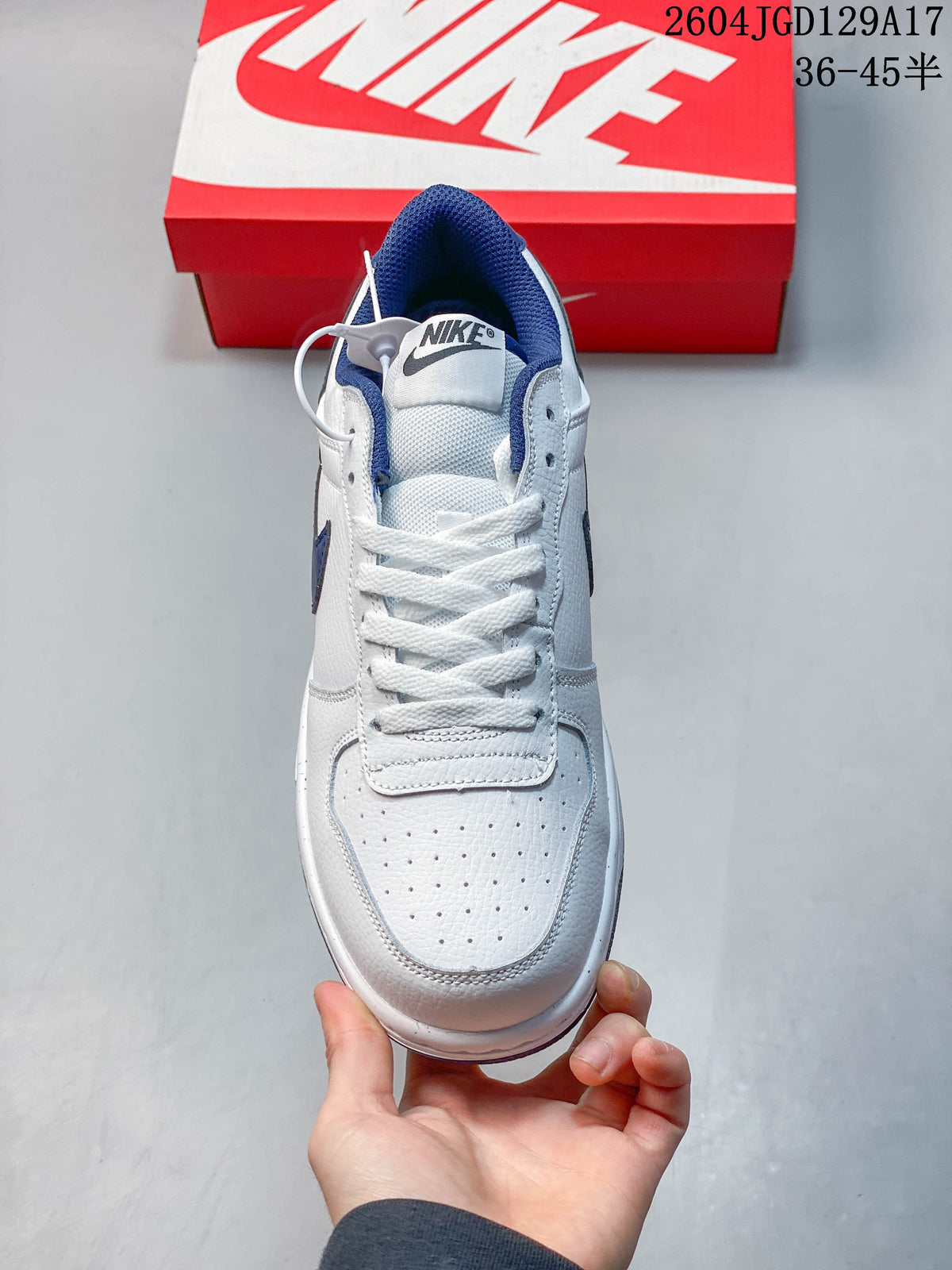 Top view of the white Nike sneaker with blue collar lining and perforated toe