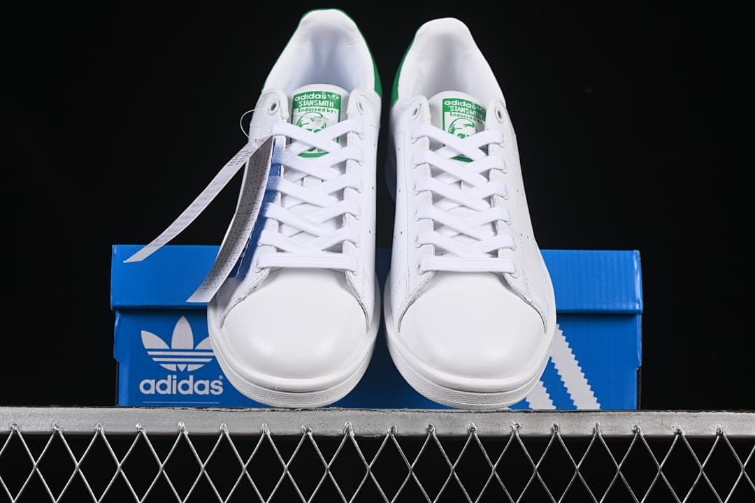 Front view of the pair displayed on a blue adidas shoebox