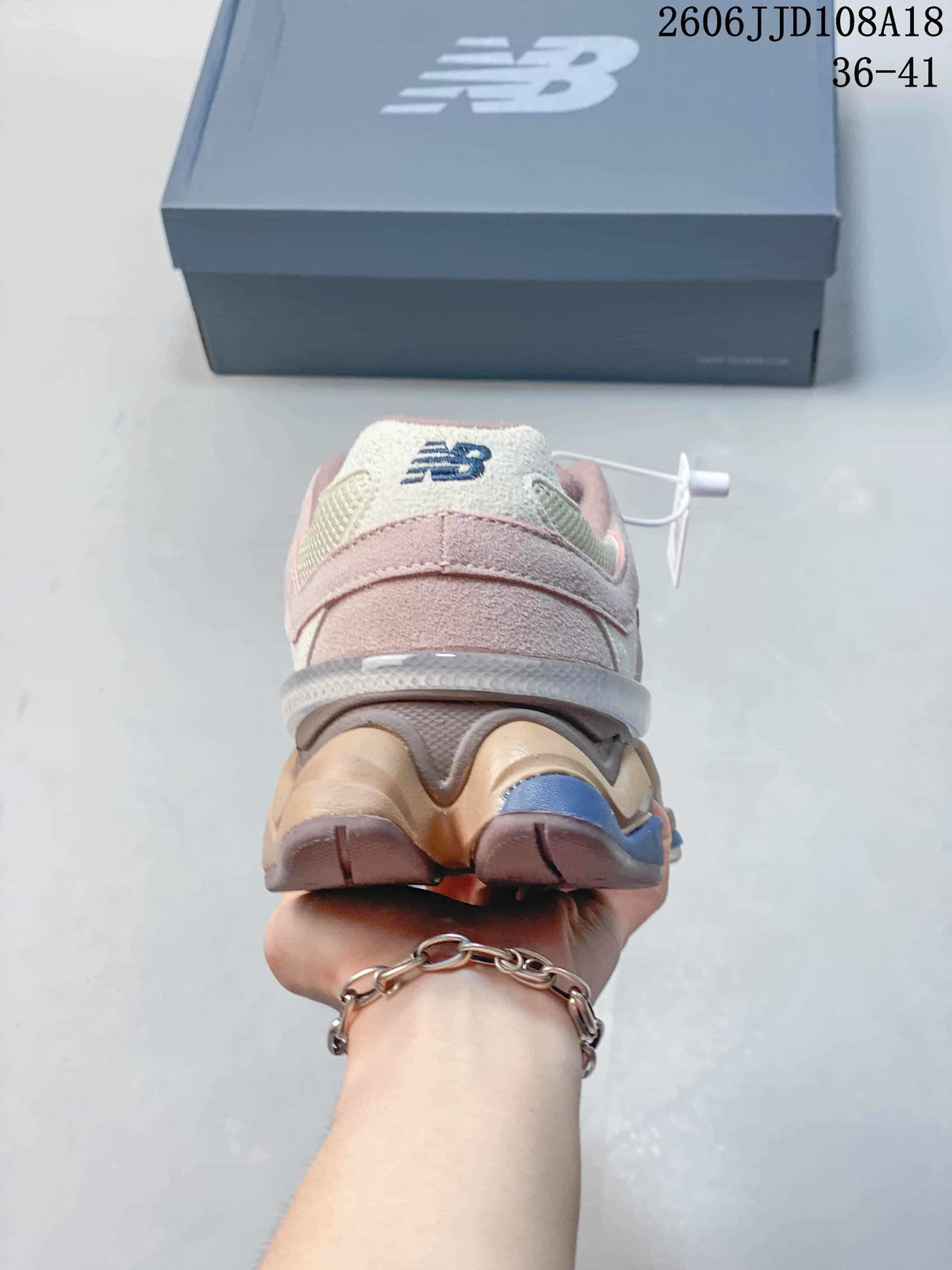 Rear view of a pink and cream New Balance 9060 sneaker