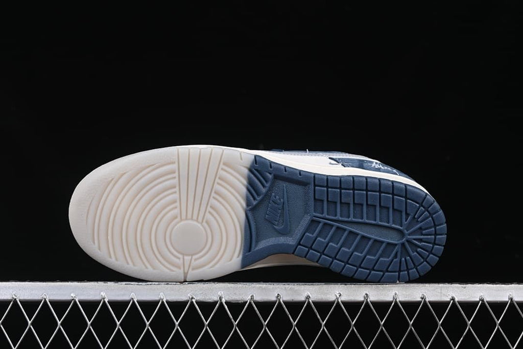 Underside view showing a two-color outsole with circular and block tread patterns
