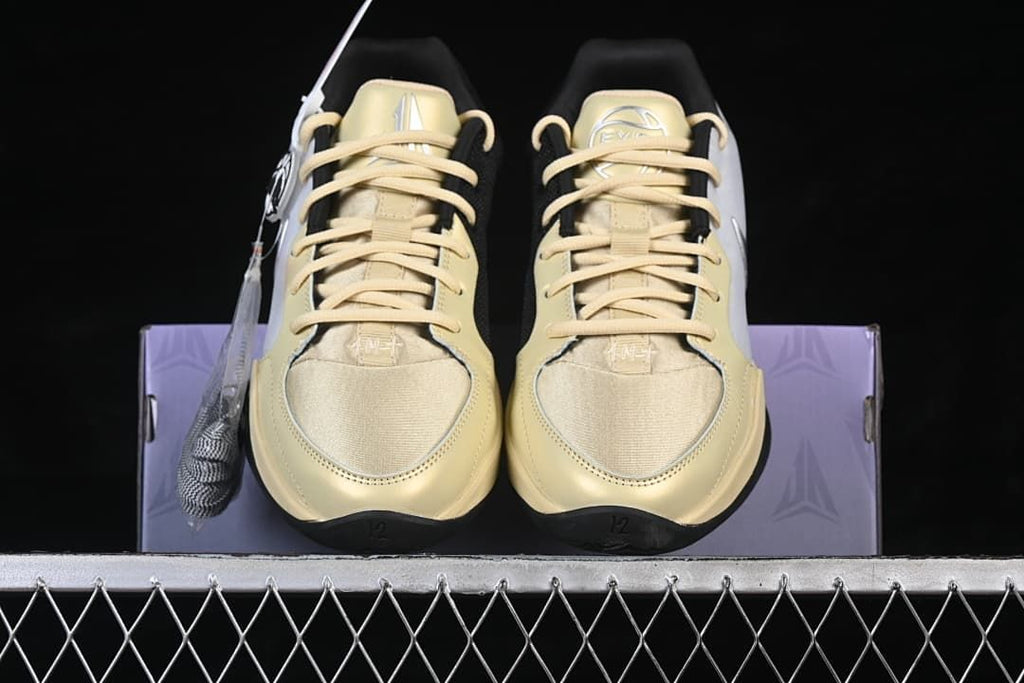 Front view of the pair with pale yellow laces and toe panels