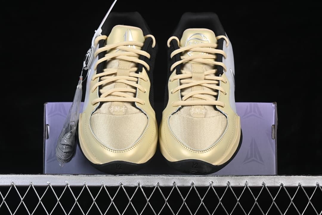 Front view of the pair with pale yellow laces and toe panels
