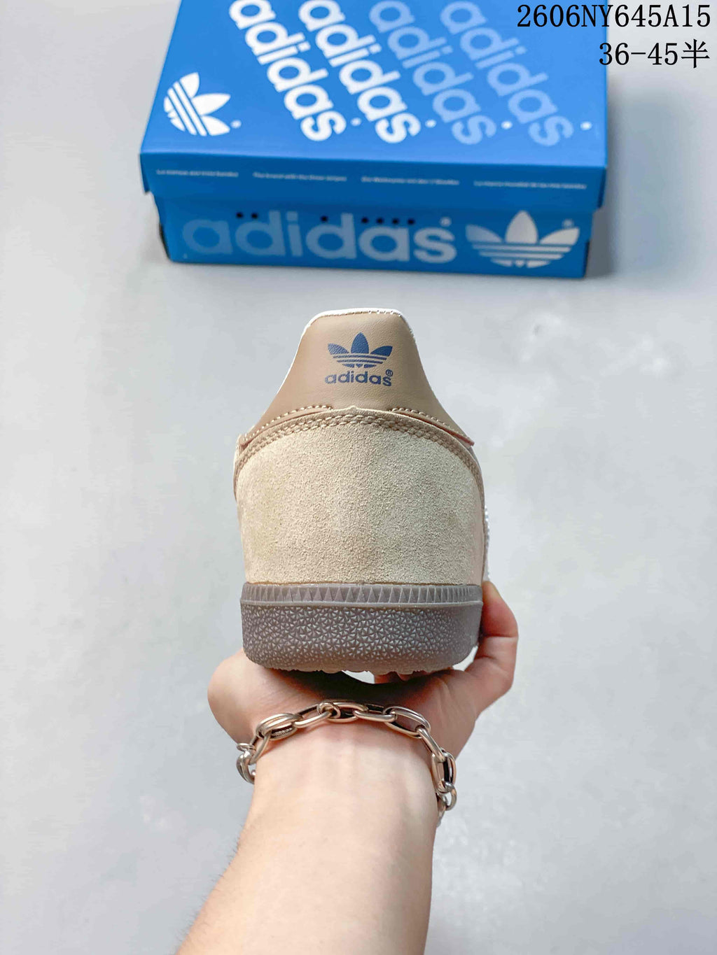 Rear view of the taupe sneaker showing its heel panel and gum-colored sole.