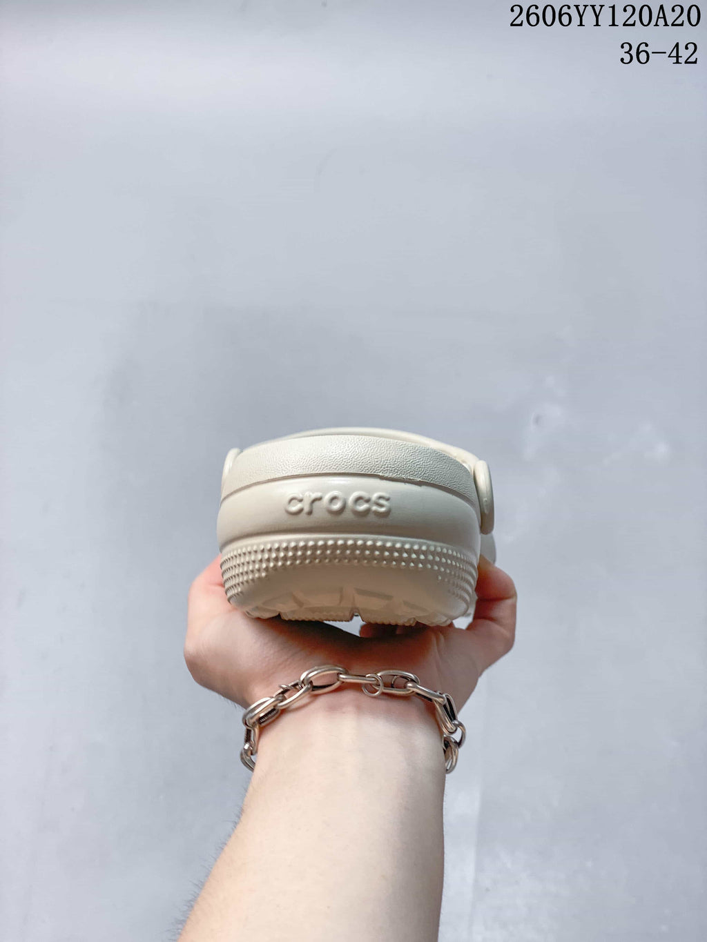 Rear view of the cream clog showing the heel and textured outsole edge.